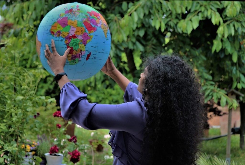 woman holding globe compressed