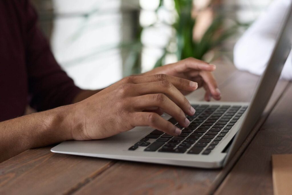 Man typing using a laptop