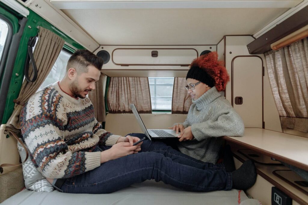 Woman with a laptop working from a van